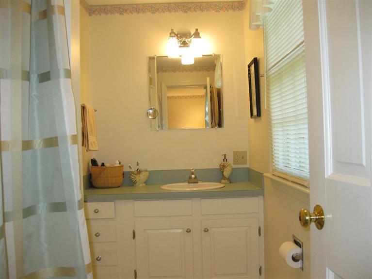 52 Clark Road Brewster, MA 02631 - Photo 16 of 32 a bathroom with a granite countertop sink a mirror and shower