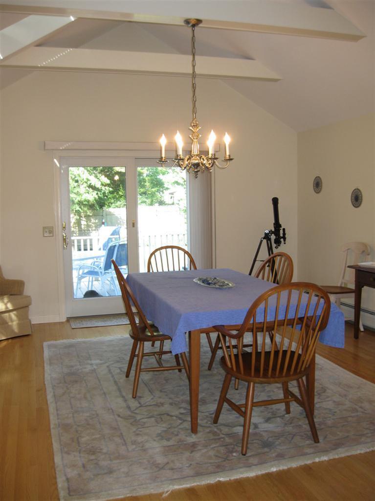 52 Clark Road Brewster, MA 02631 - Photo 20 of 32 a dining room with furniture a chandelier and window