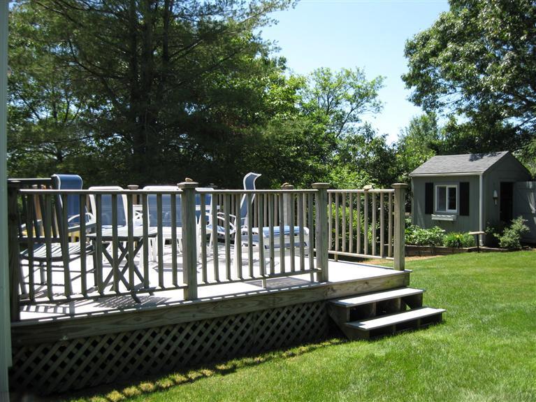 52 Clark Road Brewster, MA 02631 - Photo 23 of 32 a view of a deck with a wooden fence