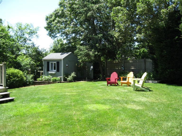52 Clark Road Brewster, MA 02631 - Photo 25 of 32 a view of a house with backyard and sitting area