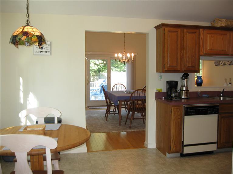 52 Clark Road Brewster, MA 02631 - Photo 26 of 32 a dining room with furniture and a chandelier