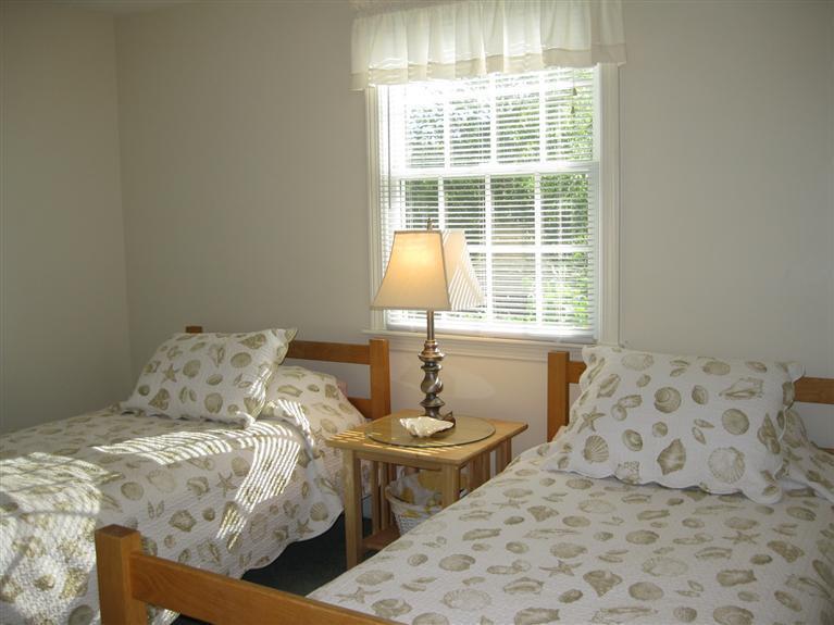 52 Clark Road Brewster, MA 02631 - Photo 27 of 32 a bedroom with a bed and a window