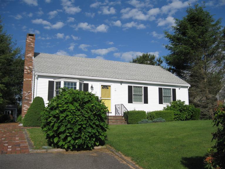 52 Clark Road Brewster, MA 02631 - Photo 31 of 32 a front view of a house with a yard