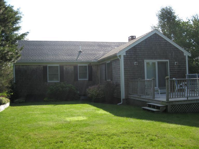 52 Clark Road Brewster, MA 02631 - Photo 32 of 32 a front view of a house with a garden