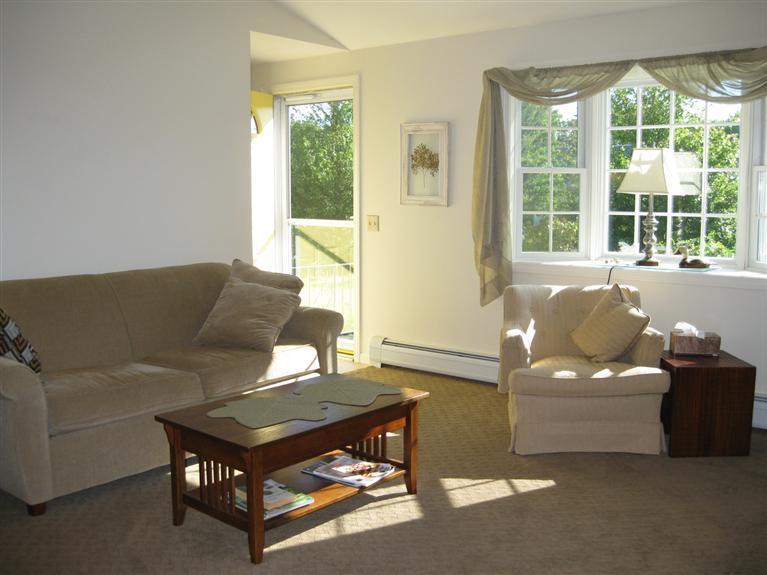 52 Clark Road Brewster, MA 02631 - Photo 7 of 32 a living room with furniture and a large window