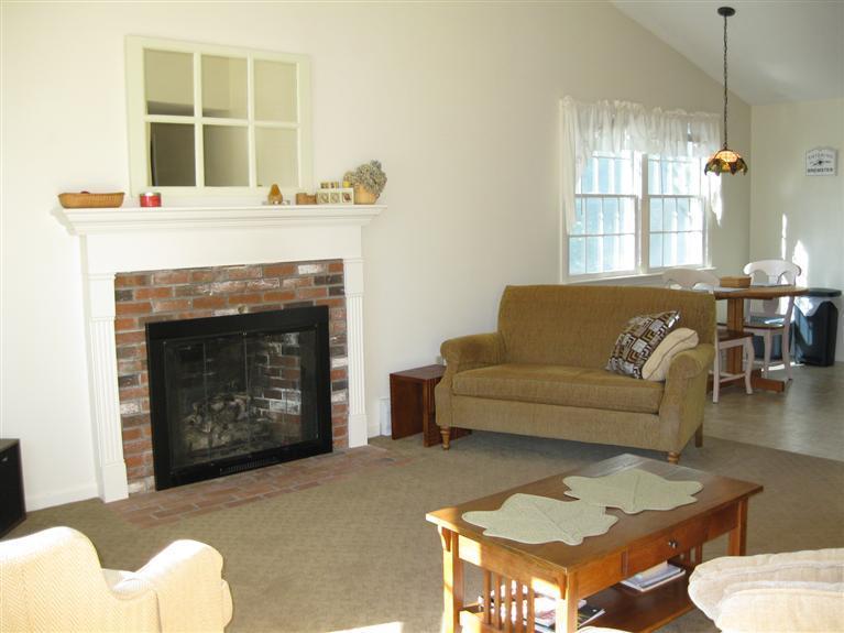 52 Clark Road Brewster, MA 02631 - Photo 9 of 32 a living room with furniture and a fireplace