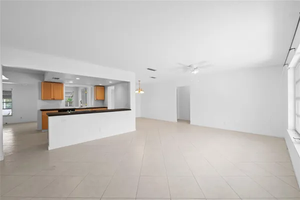 a view of an empty room with kitchen