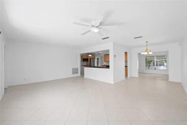an empty room with closet and ceiling fan