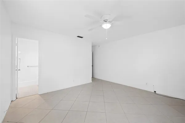 an empty room with a fan