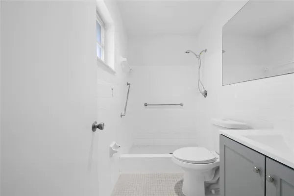 a bathroom with a toilet a sink and shower