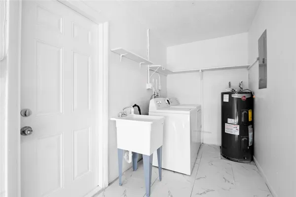a utility room with cabinets washer and dryer