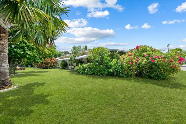 a view of a garden with a building in the background