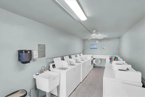 a utility room with cabinets washer and dryer