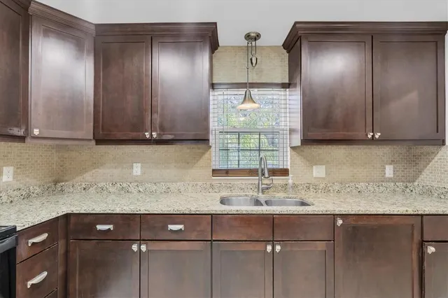 a kitchen with a sink a cabinets and window