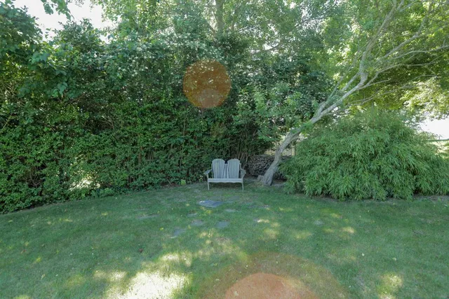 a view of a house with swimming pool and a yard