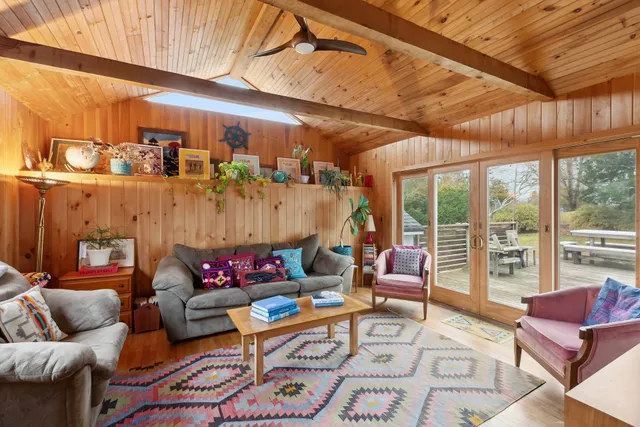a living room with furniture and a floor to ceiling window