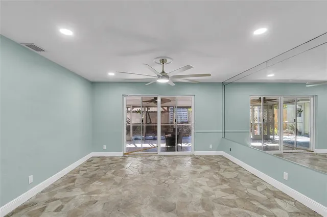 an empty room with kitchen and window