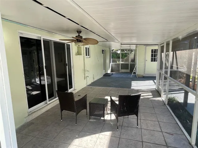 a view of a patio with table and chairs
