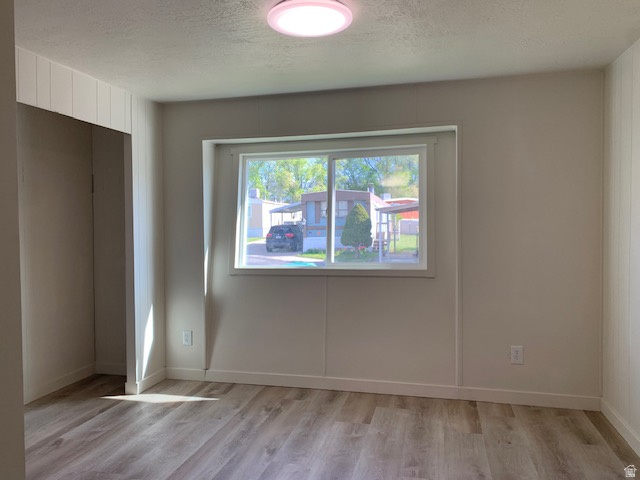 1500 North Angel Street West, Unit 56 Layton, UT 84041 - Photo 12 of 20 Primary Suite featuring a textured ceiling and light wood-style flooring