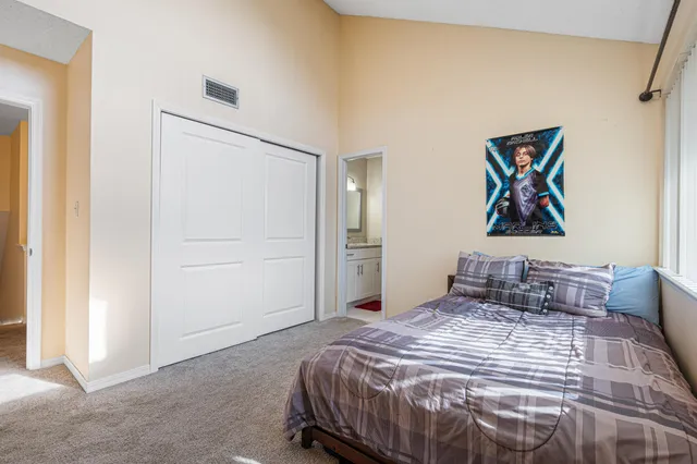 a bathroom with a granite countertop toilet sink and mirror