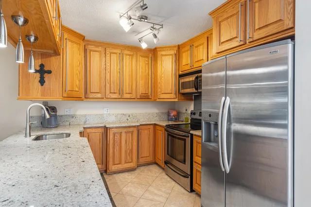 a kitchen with cabinets a sink and appliances