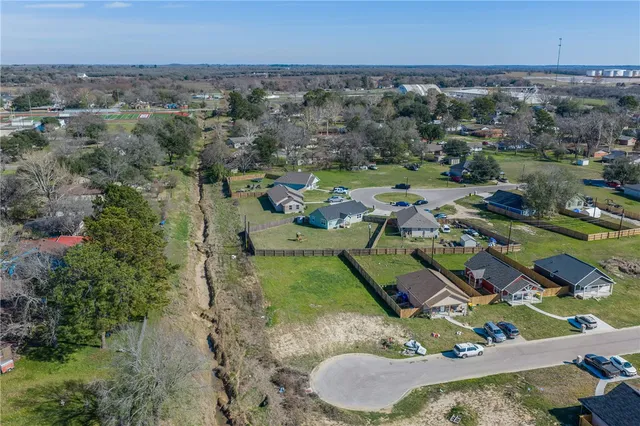 an aerial view of a residential houses with outdoor space
