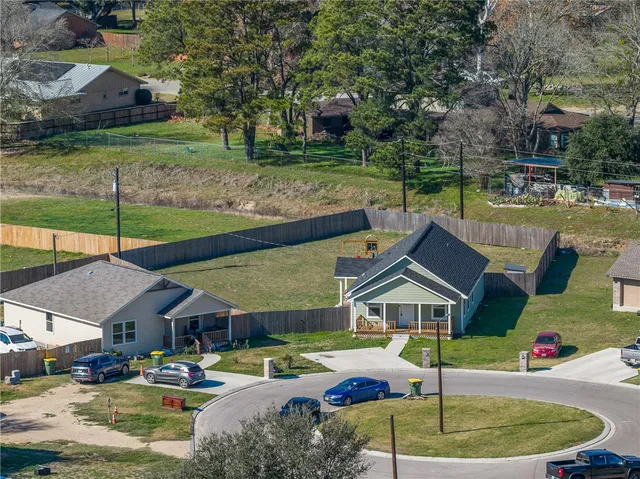 a roof deck with table and chairs under an umbrella