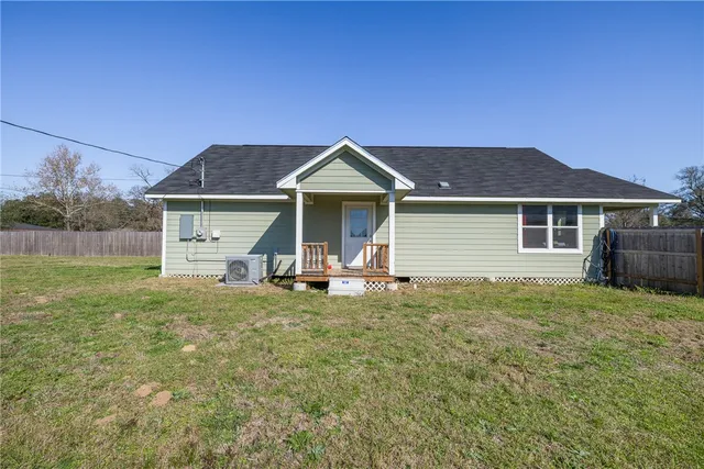a front view of a house with a garden and porch