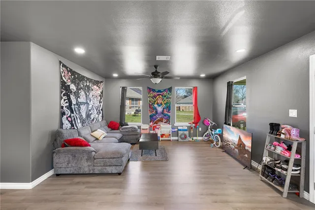 a living room with lots of furniture and a wooden floor