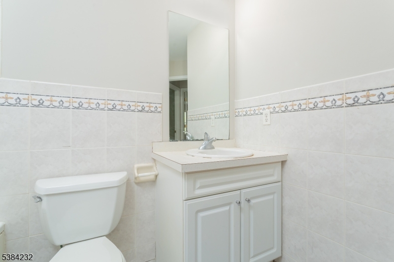 637 Old Dover Road Morris Plains, NJ 07950 - Photo 17 of 28 a bathroom with a sink a toilet and mirror