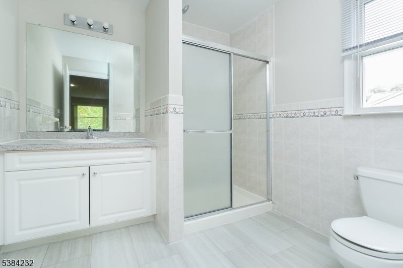 637 Old Dover Road Morris Plains, NJ 07950 - Photo 22 of 28 a bathroom with a toilet a sink a vanity and mirror