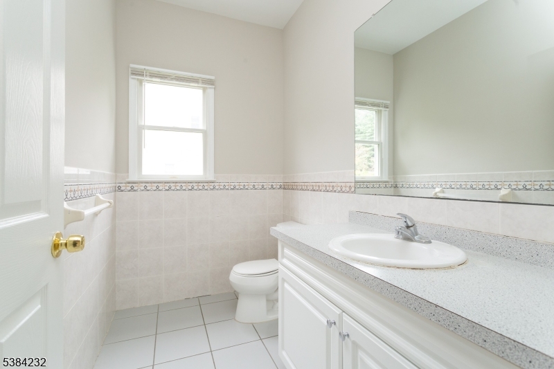 637 Old Dover Road Morris Plains, NJ 07950 - Photo 5 of 28 a bathroom with a sink a toilet and a mirror