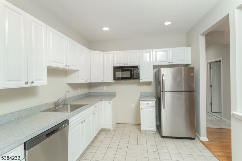 637 Old Dover Road Morris Plains, NJ 07950 - Photo 8 of 28 a kitchen with a refrigerator sink and cabinets