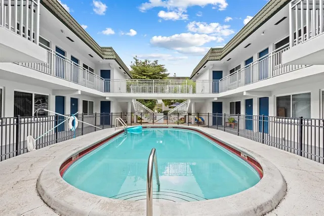 swimming pool view with a outdoor seating