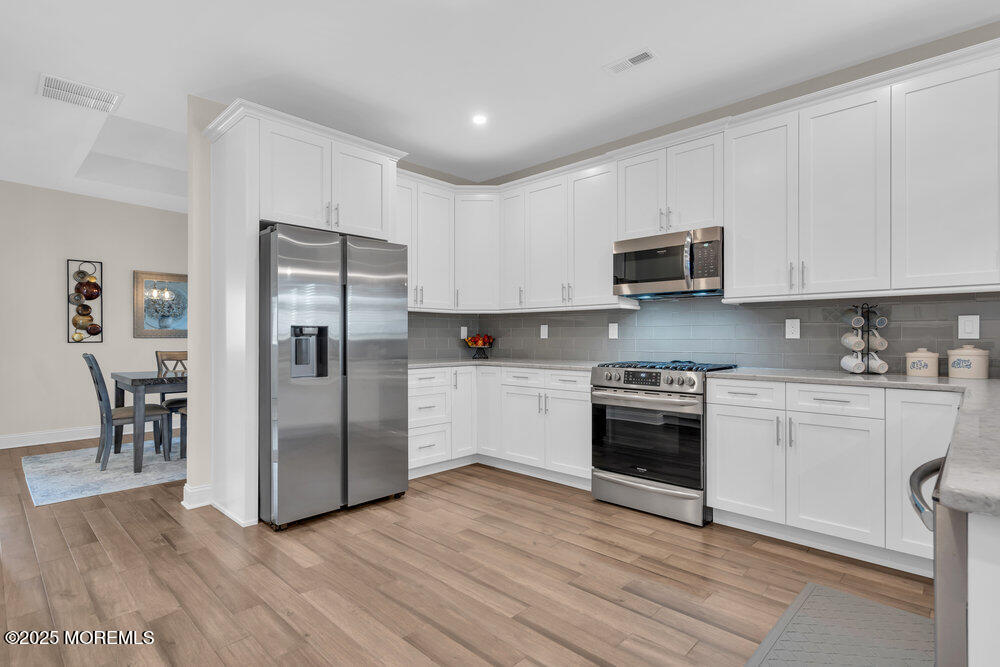 65 Moonlight Drive Barnegat, NJ 08005 - Photo 14 of 68 a kitchen with stainless steel appliances granite countertop a refrigerator a stove top oven a sink and dishwasher