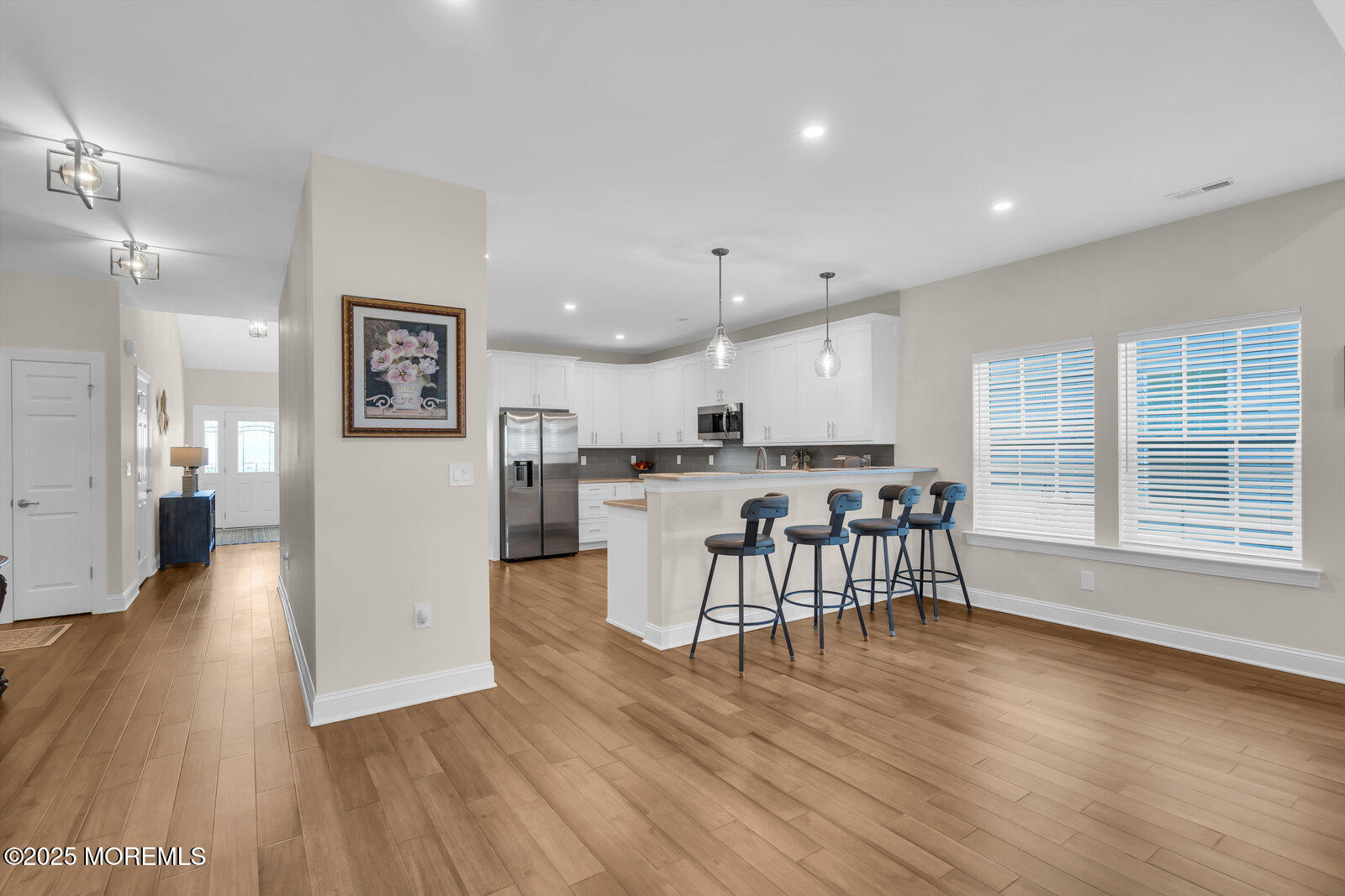 65 Moonlight Drive Barnegat, NJ 08005 - Photo 19 of 68 a kitchen with stainless steel appliances granite countertop a stove top oven a sink dishwasher a dining table and chairs with wooden floor