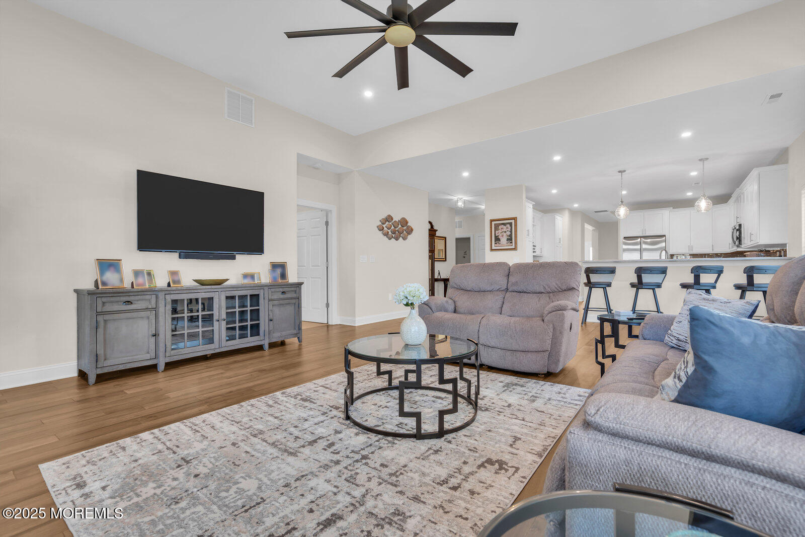 65 Moonlight Drive Barnegat, NJ 08005 - Photo 23 of 68 a living room with furniture and a flat screen tv with wooden floor