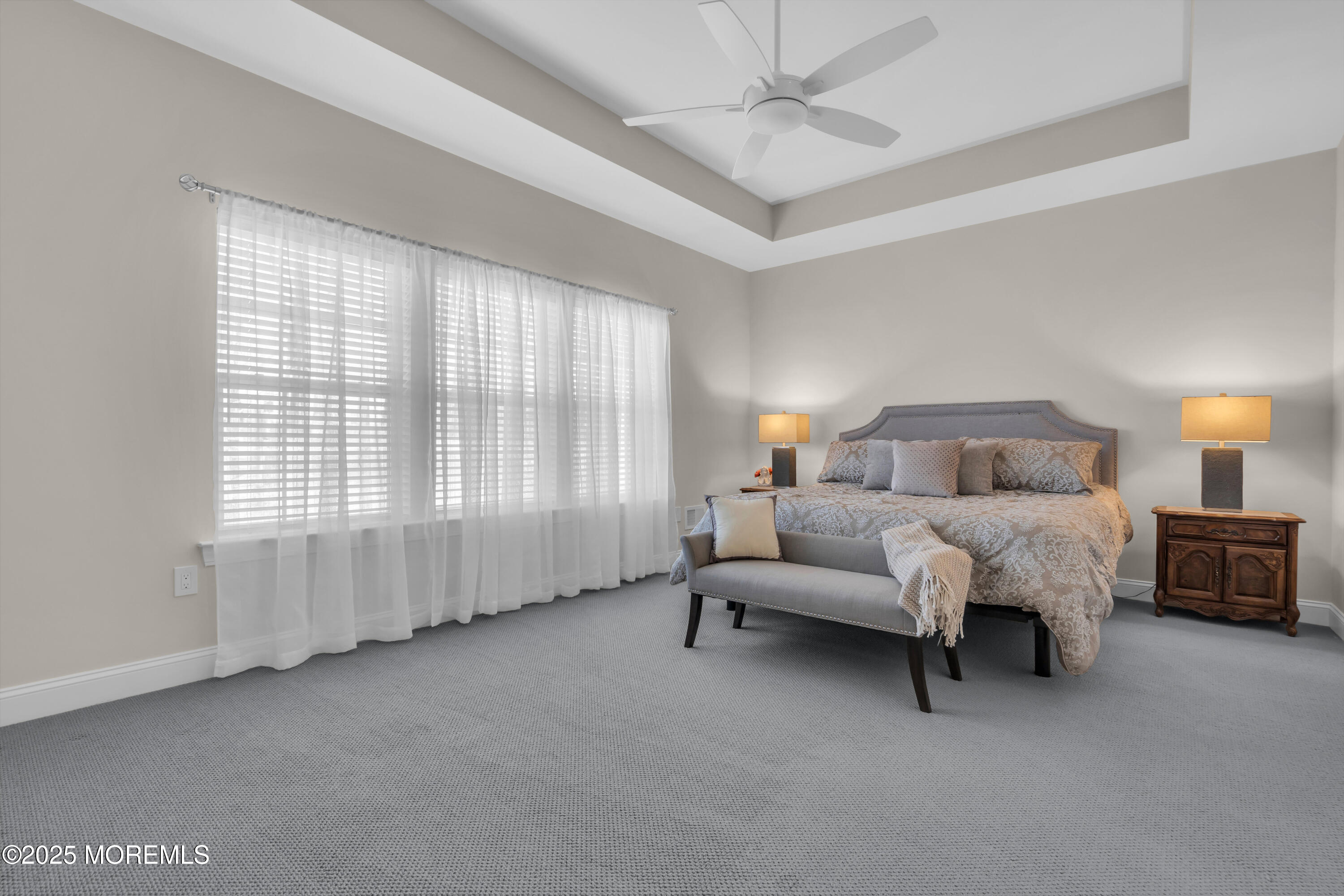 65 Moonlight Drive Barnegat, NJ 08005 - Photo 25 of 68 a spacious bedroom with a bed and a chandelier