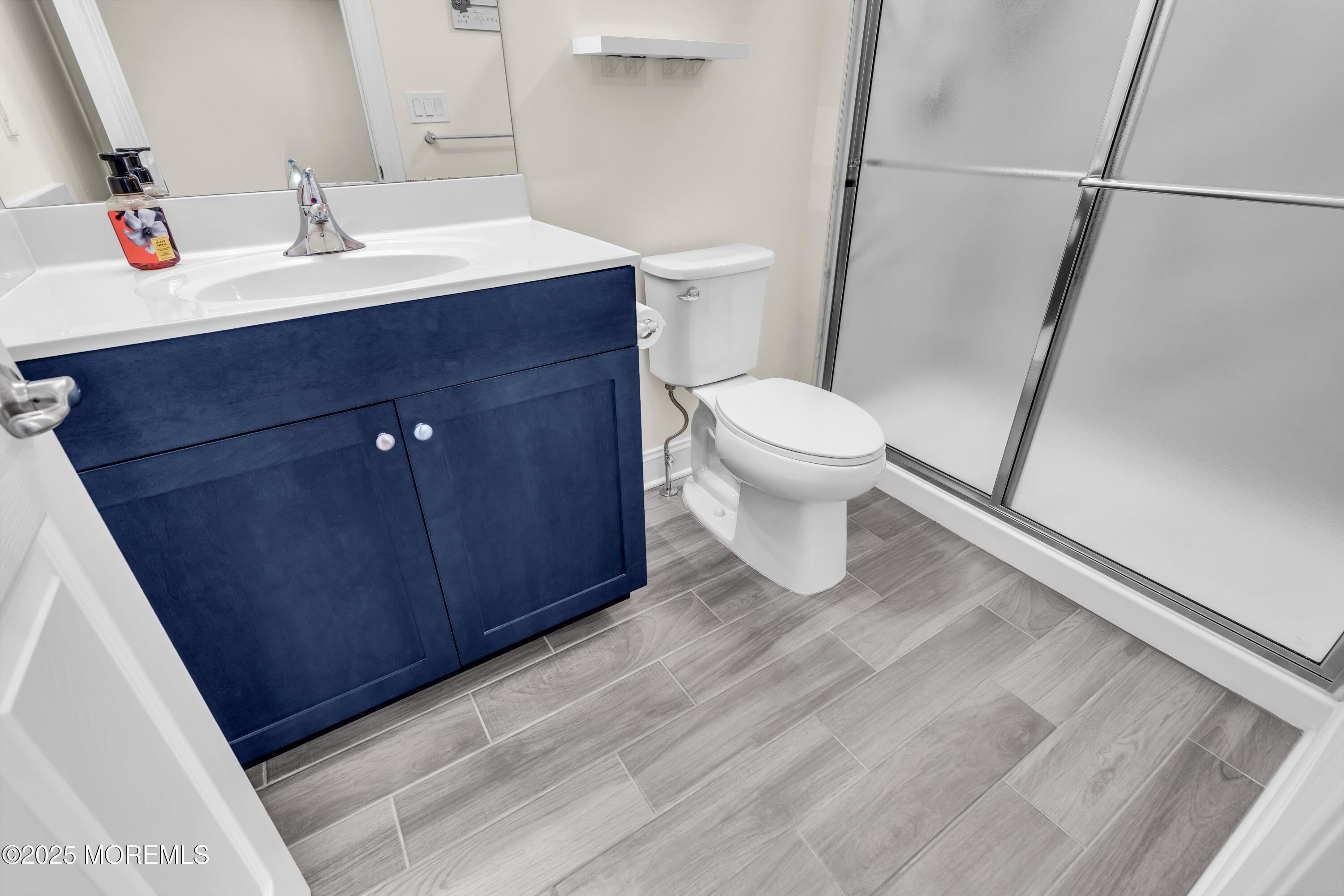 65 Moonlight Drive Barnegat, NJ 08005 - Photo 34 of 68 a bathroom with a sink and a mirror