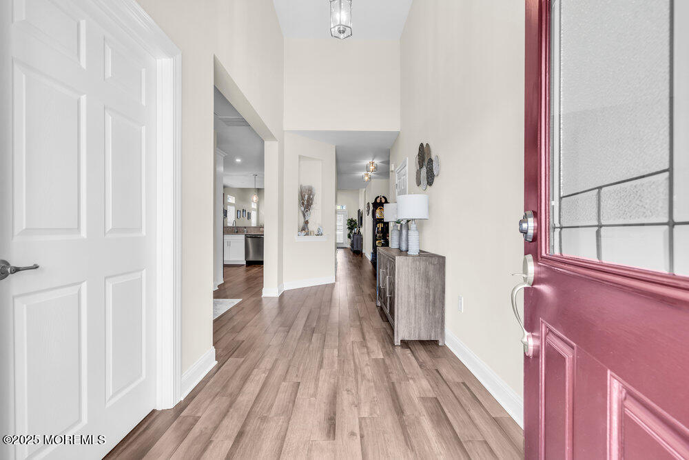 65 Moonlight Drive Barnegat, NJ 08005 - Photo 9 of 68 a view of a hallway with wooden floor and staircase