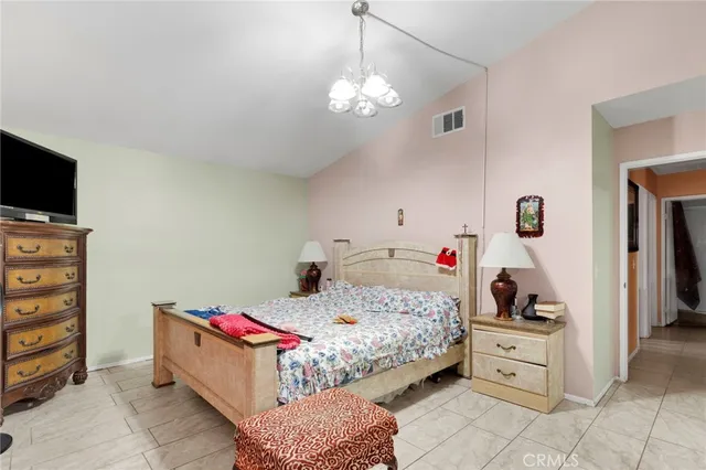 a bedroom with a bed and flat screen tv