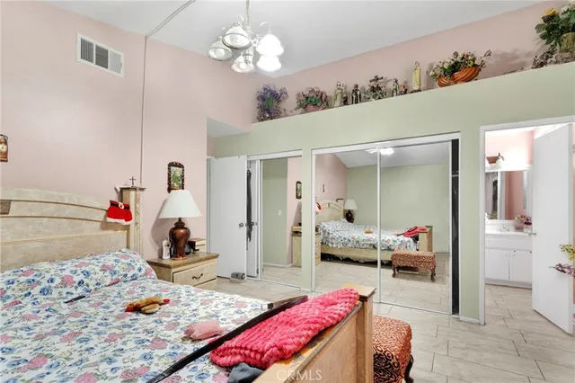 a bedroom with furniture and a chandelier
