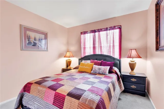 a bedroom with a bed and a lamp