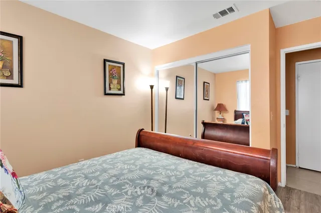 a bedroom with a large bed and a dresser