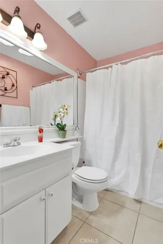 a bathroom with a sink a toilet and shower curtain