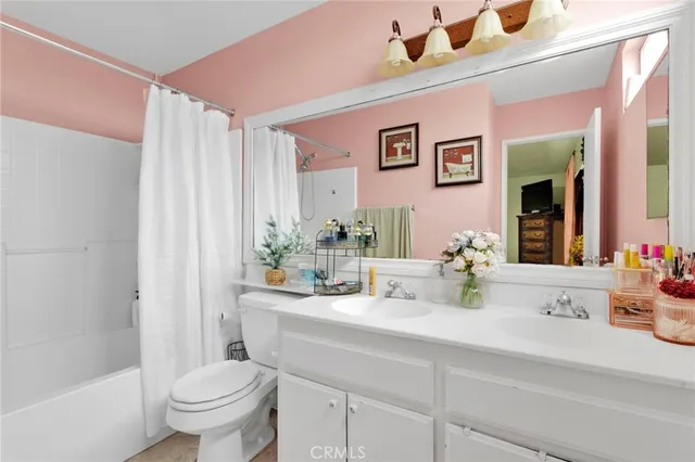 a bathroom with a sink a toilet and shower curtain