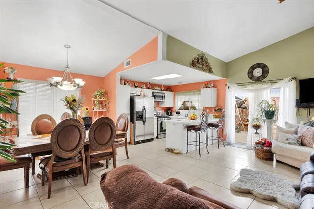 a view of a dining room and livingroom with furniture wooden floor and a rug