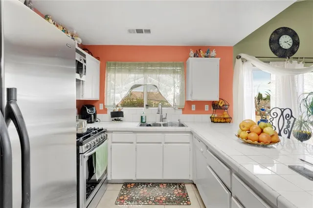 a kitchen with a sink appliances and cabinets