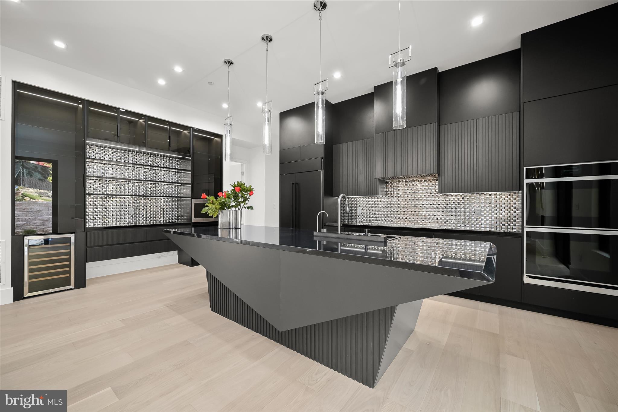4509 Foxhall Crescent Northwest Washington, DC 20007 - Photo 11 of 39 a large kitchen with kitchen island a large counter top stainless steel appliances and cabinets