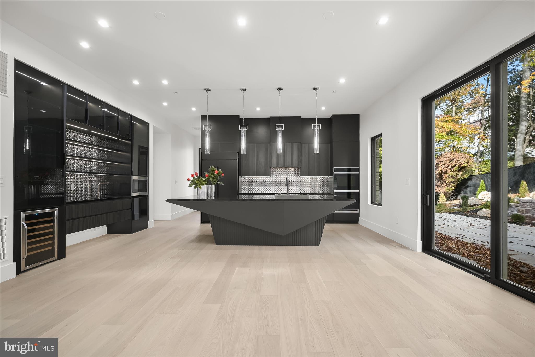 4509 Foxhall Crescent Northwest Washington, DC 20007 - Photo 13 of 39 a large living room with stainless steel appliances kitchen island granite countertop a large counter top and a view of living room